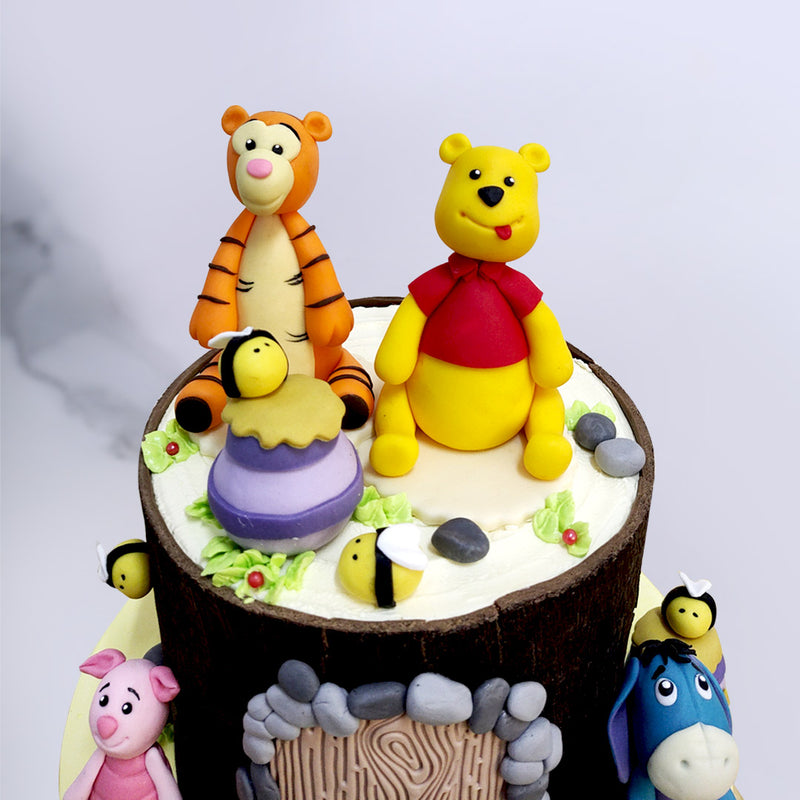 The bottom tier of this  Winnie the Pooh birthday cake for kids comes in a buttery yellow making it more vibrant and drool-worthy, perfectly contrasting the colour of the electric black top tier which has been shaped like Winnie the Pooh's house.