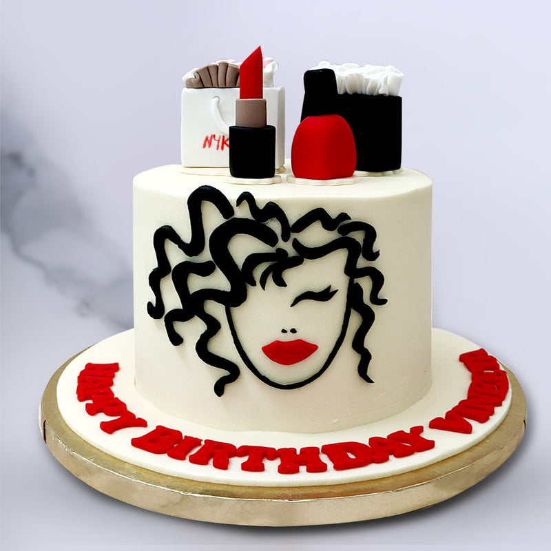Even though this woman face cake is the gift that keeps on giving in regards to cakes for her, there are also two gift bags proudly displayed on top, with one being from Nykaa along with a red lipstick (matching the portrait in the cake) and red nail polish too. We've even recreated the paper stuffed inside it to add more to the detailing on this silhouette lady face cake design. 