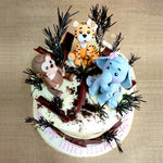 As we like to say at Liliyum Patisserie, the real show stopper is the woodland animal cake topper: three figurines of friendly forest creatures: a monkey, a tiger and a blue elephant all sitting facing each other like they're having a little tea party. 