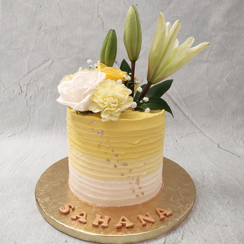 This yellow floral cake or yellow flower cake design is the ultimate centrepiece that combines the deliciousness of a festive dessert with the beauty of a floral bouquet.
